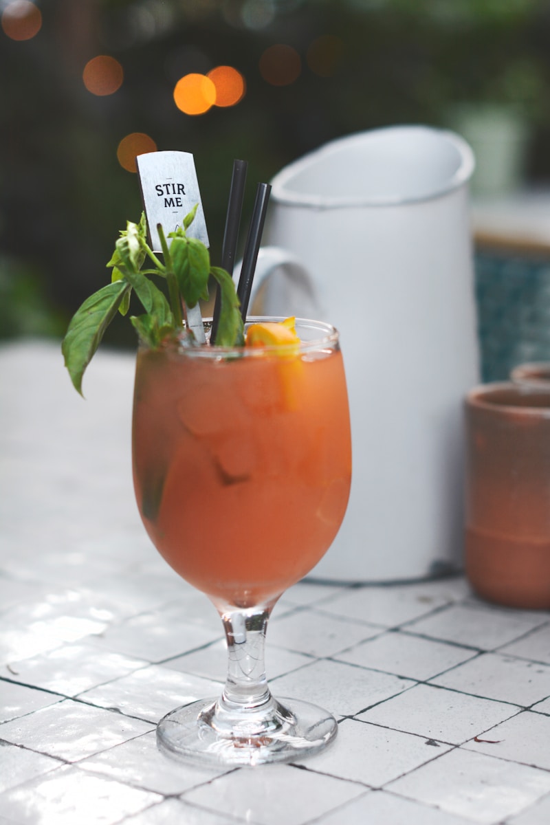 wine glass with juice in shallow focus photography